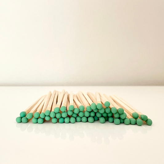 9.8 cm green matches on surface.