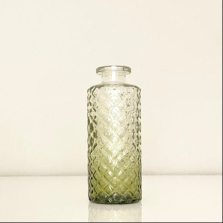 Textured green glass vase on a white background.Perfect for displaying fresh or dried flowers, adding a minimalist yet elegant touch to your home decor.