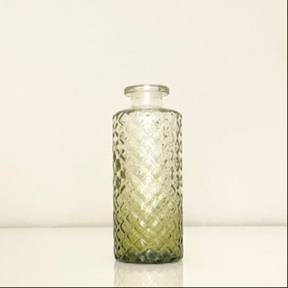 Textured green glass vase on a white background.Perfect for displaying fresh or dried flowers, adding a minimalist yet elegant touch to your home decor.