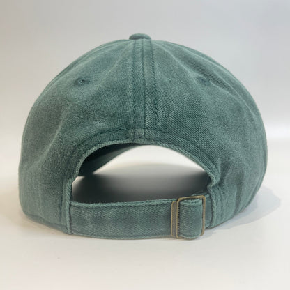 Green cap with metal clasp on white background. 