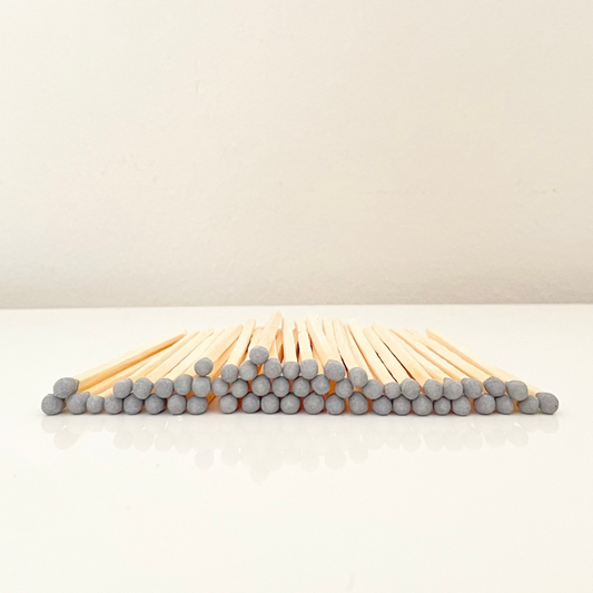 4.8 cm grey matches on a white surface. 