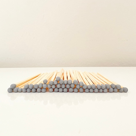 7.5 cm grey matches on a white surface. 