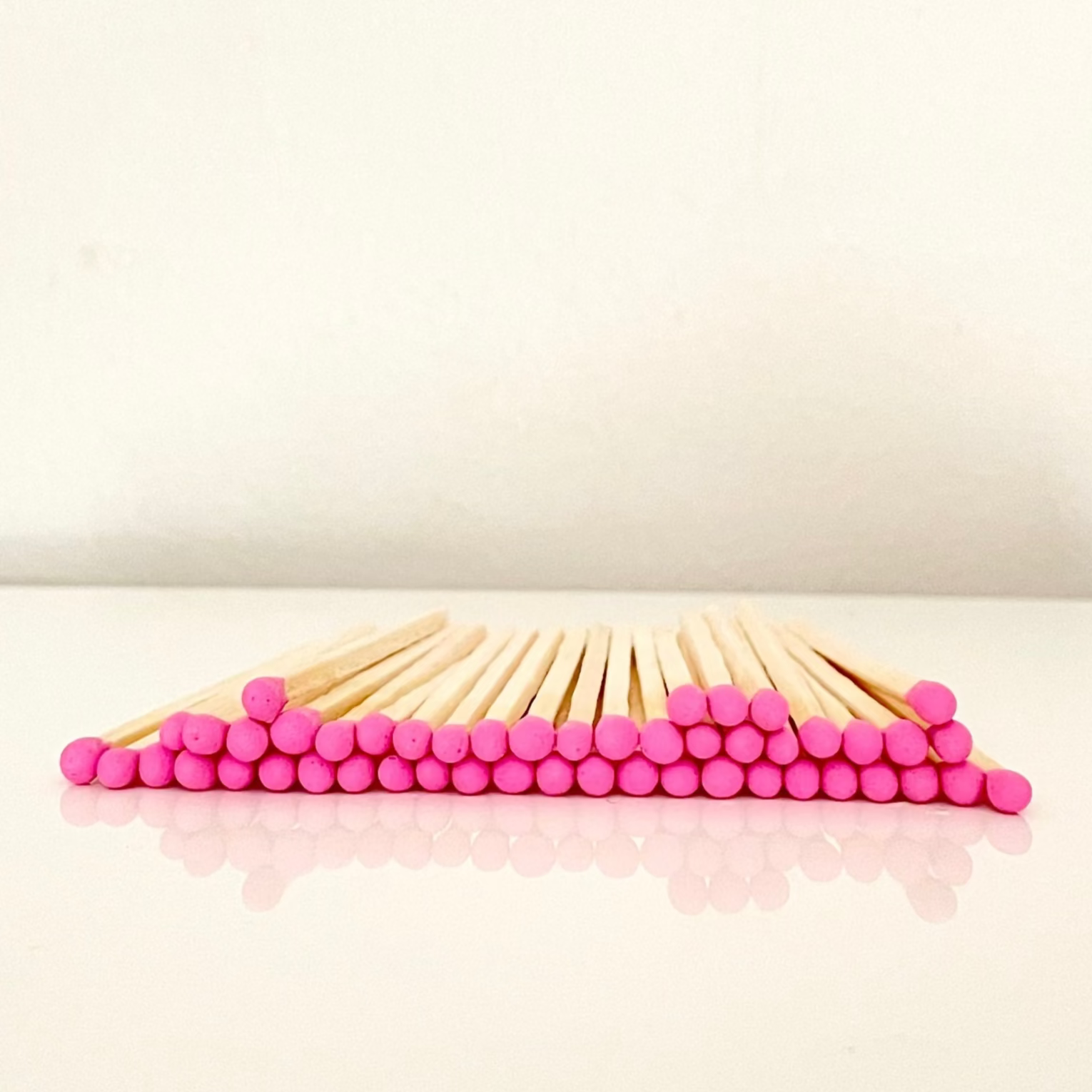4.8 cm hot pink matches on a white surface. 
