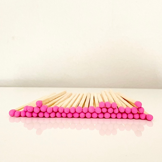 4.8 cm hot pink matches on a white surface. 