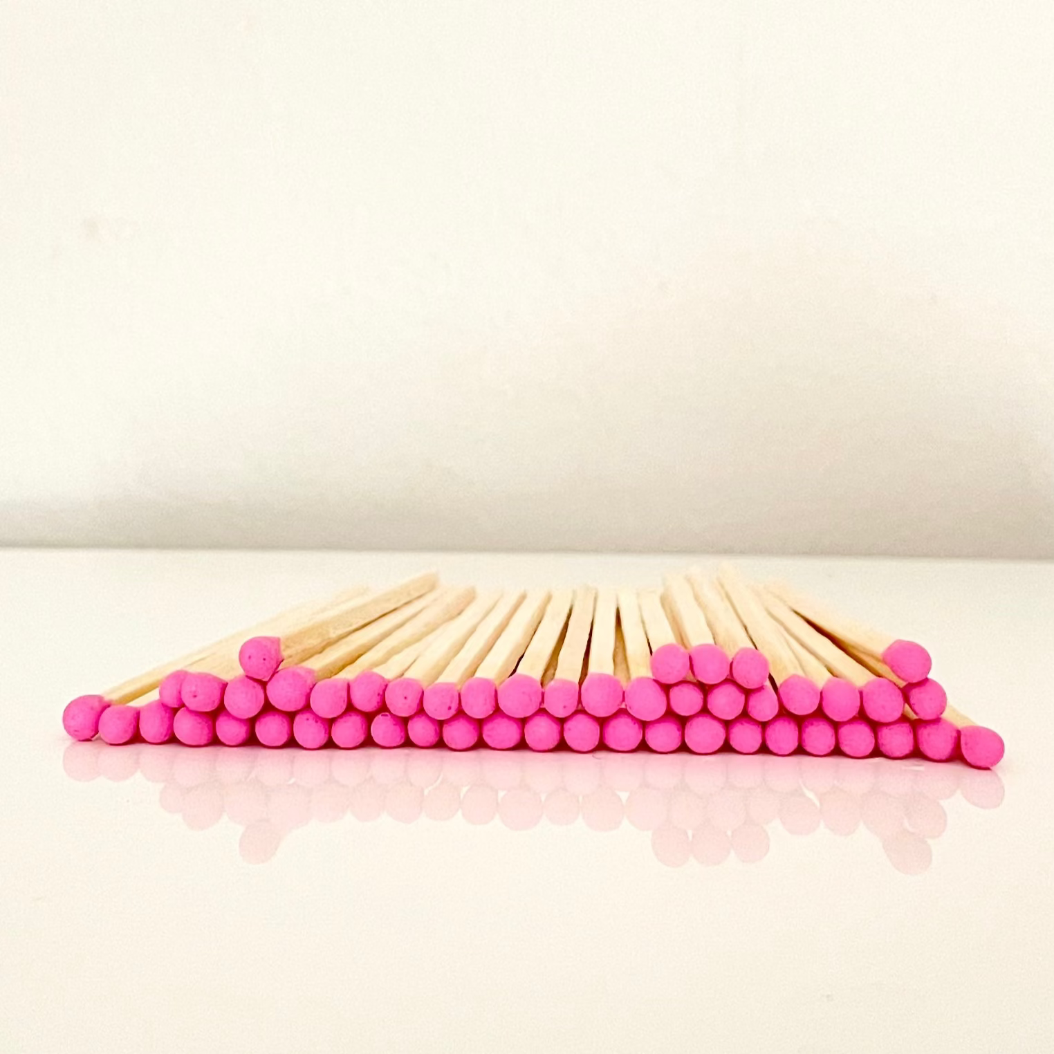 7.5 cm hot pink safety matches on a white surface. 