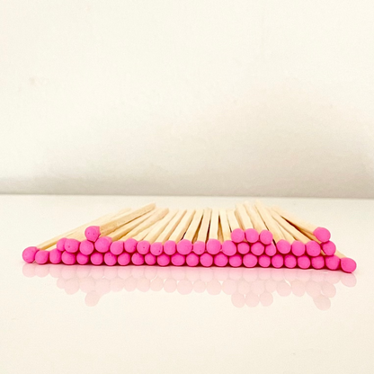 7.5 cm hot pink safety matches on a white surface. 