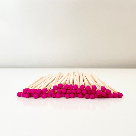 9.8 cm hot pink matches on surface.