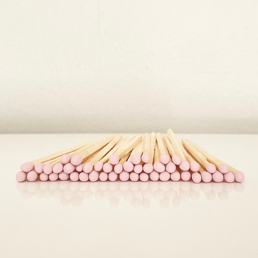 4.8 cm light pink matches on a white surface. 