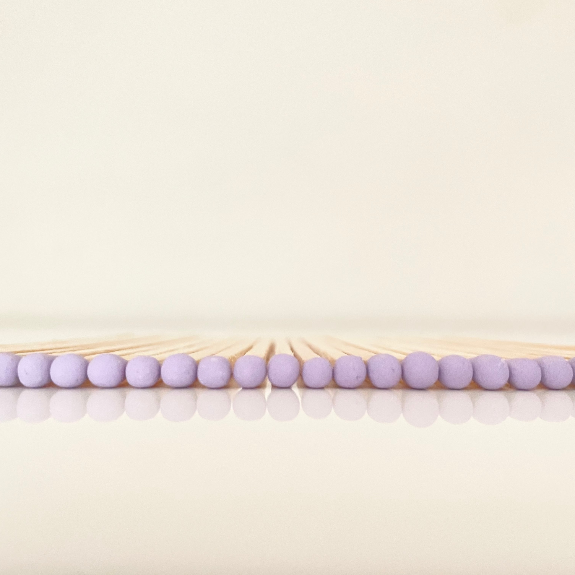 9.8 cm lilac matches on white surface.