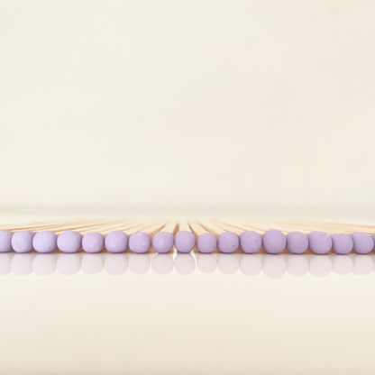 9.8 cm lilac matches on white surface.