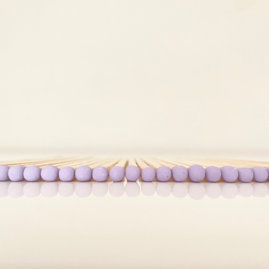 9.8 cm lilac matches on white surface.