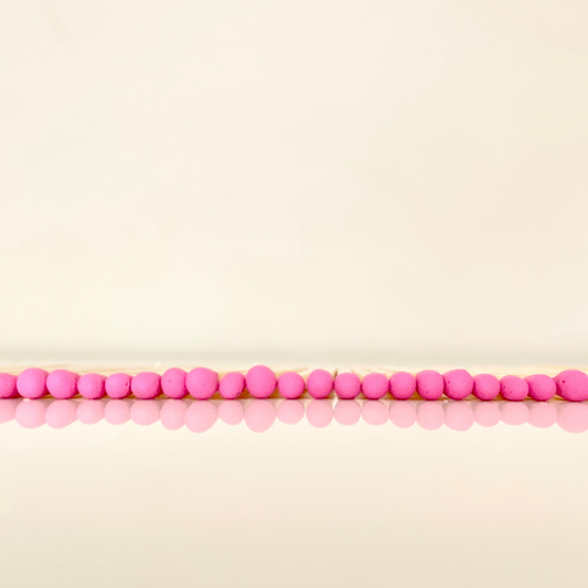 4.8 cm hot pink matches on a white surface. 