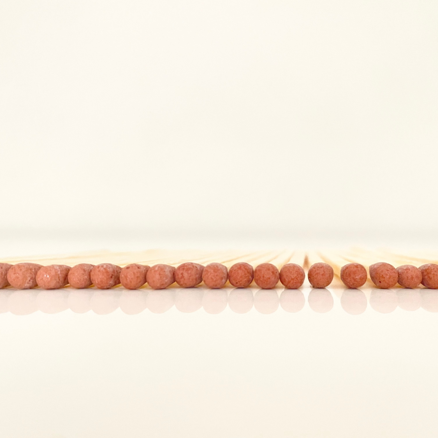 4.8 cm brown matches on a white surface. 