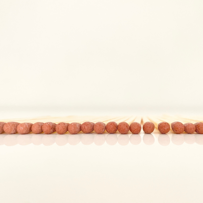 4.8 cm brown matches on a white surface. 