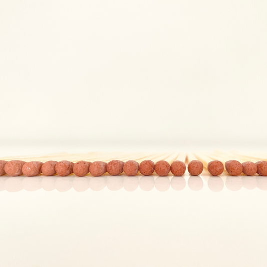 4.8 cm brown matches on a white surface. 