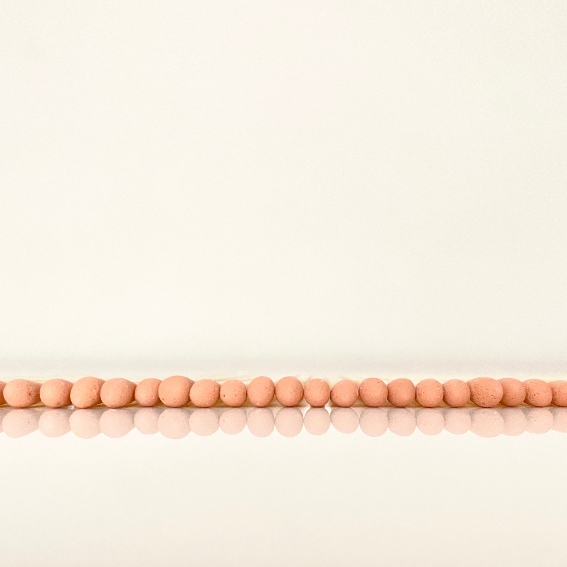 4.8 cm orange matches on a white surface. 