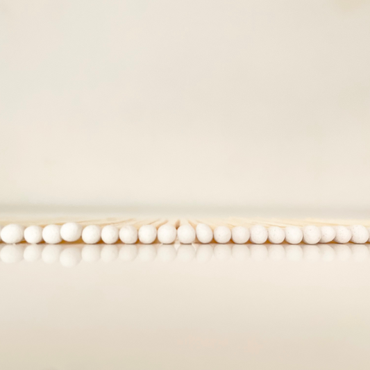 4.8 cm white matches on a white surface. 