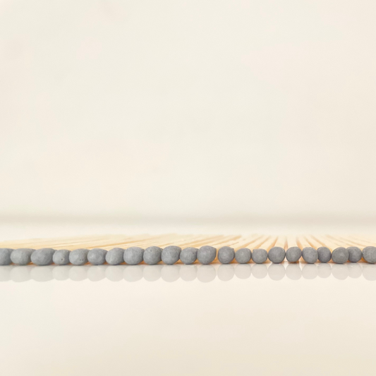 4.8 cm grey matches on a white surface. 