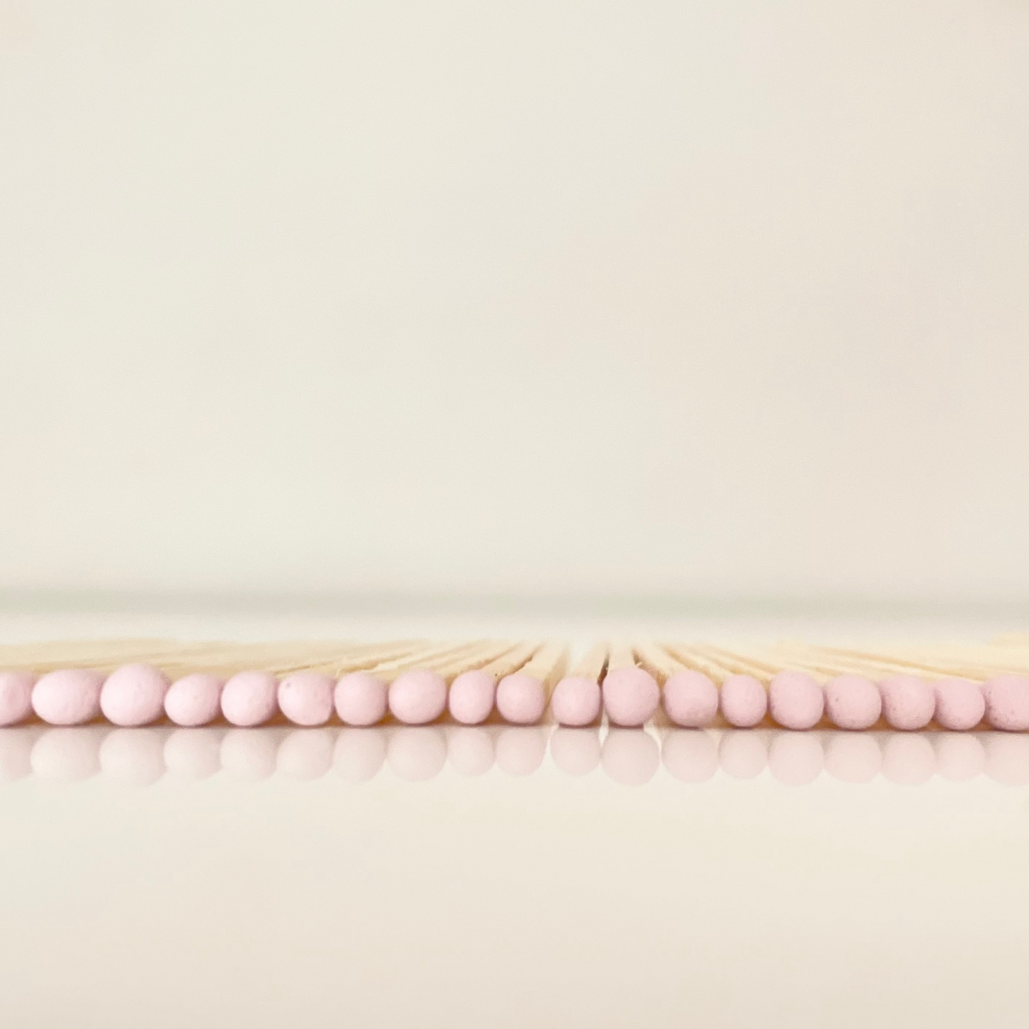 4.8 cm light pink matches on a white surface. 
