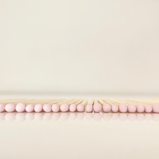 4.8 cm light pink matches on a white surface. 