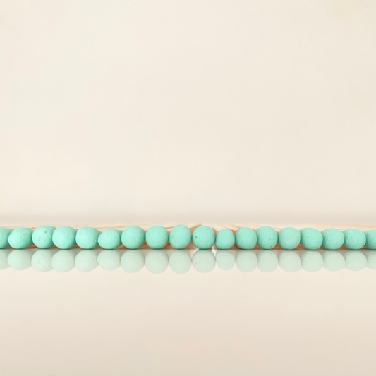 9.8 cm coral matches on white surface.