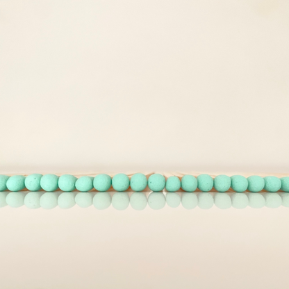 9.8 cm coral matches on white surface.