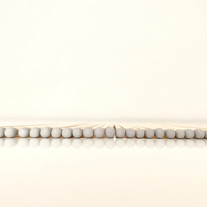 9.8 cm grey matches on white surface.