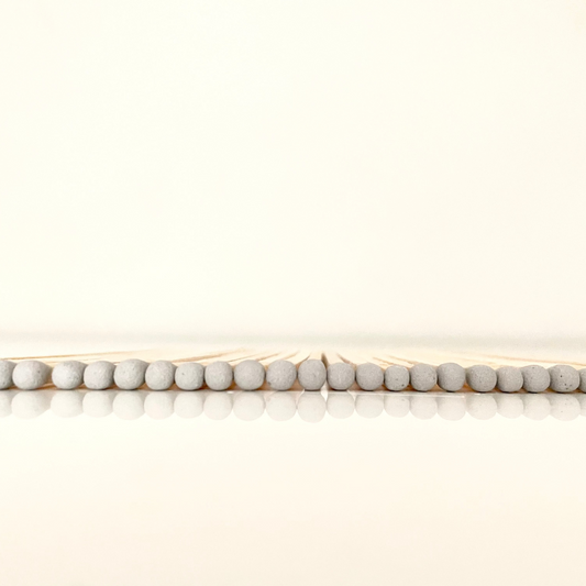 9.8 cm grey matches on white surface.