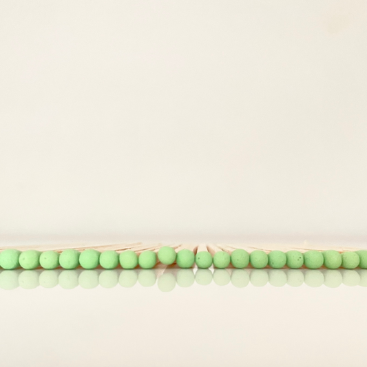 9.8 cm pistachio matches on white surface.