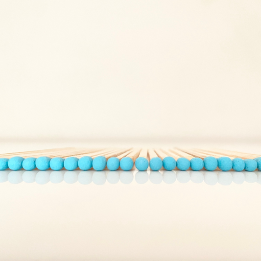 9.8 cm blue matches on white surface.