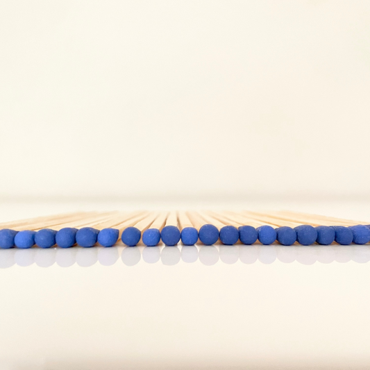 9.8 cm electric blue matches on white surface.
