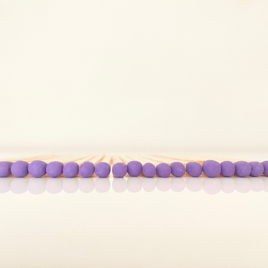 9.8 cm purple matches on white surface.