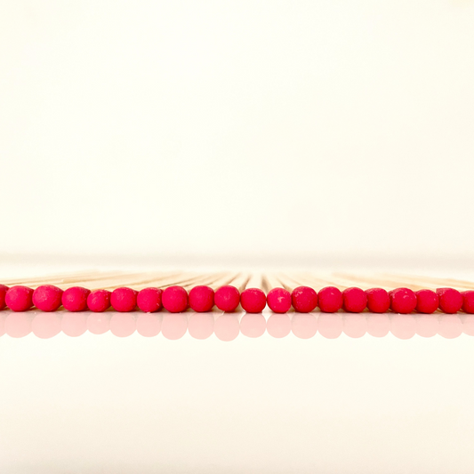 9.8 cm red matches on white surface.