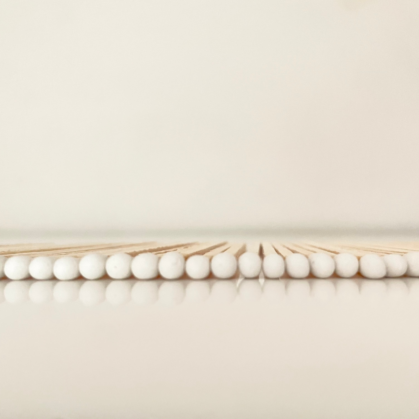9.8 cm white matches on white surface.