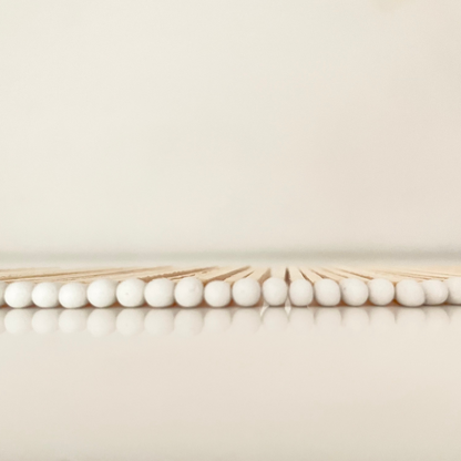 9.8 cm white matches on white surface.