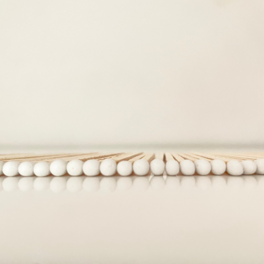 9.8 cm white matches on white surface.