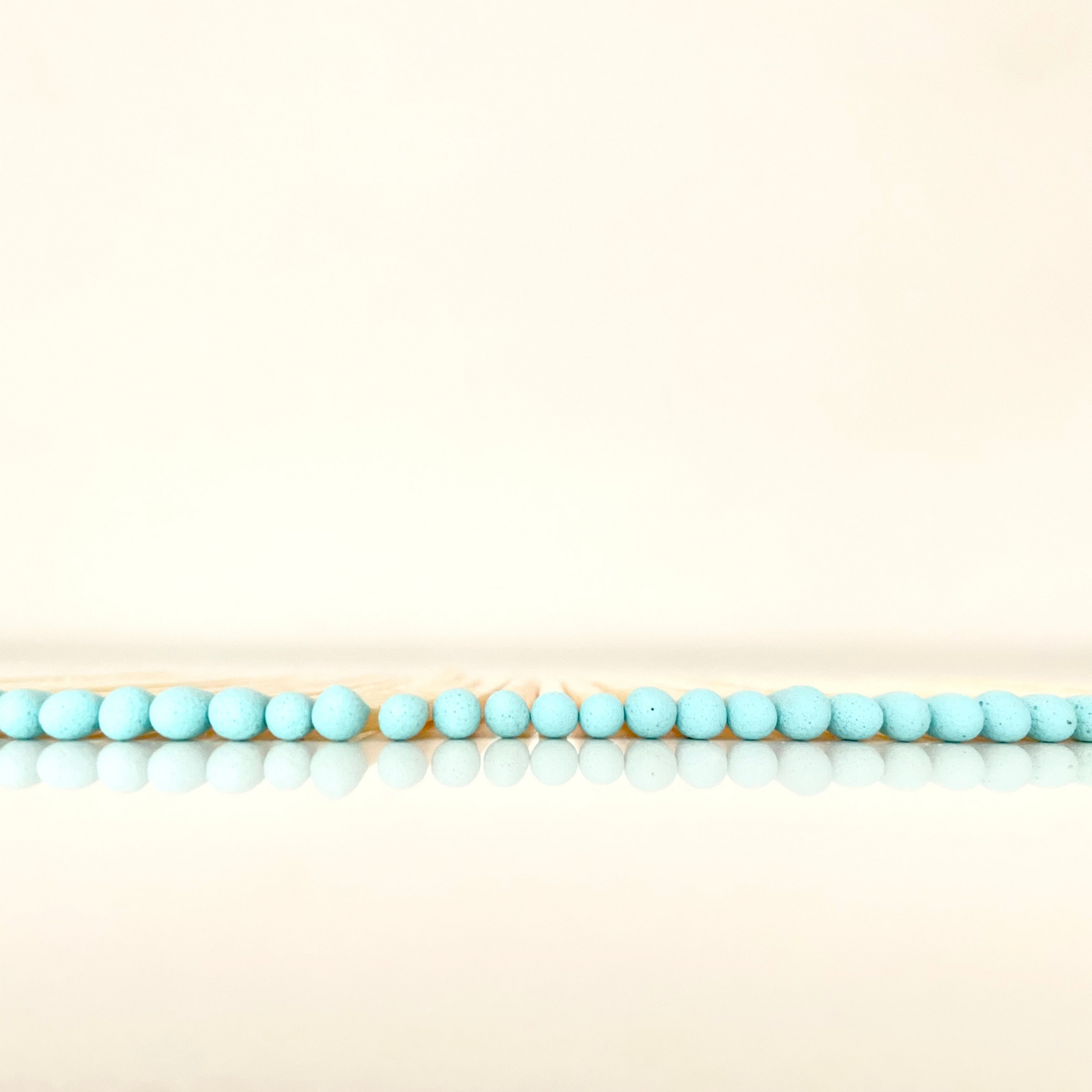 4.8 cm aqua matches on a white surface. 