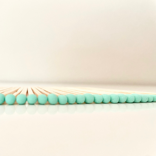 9.8 cm aqua matches on white surface.