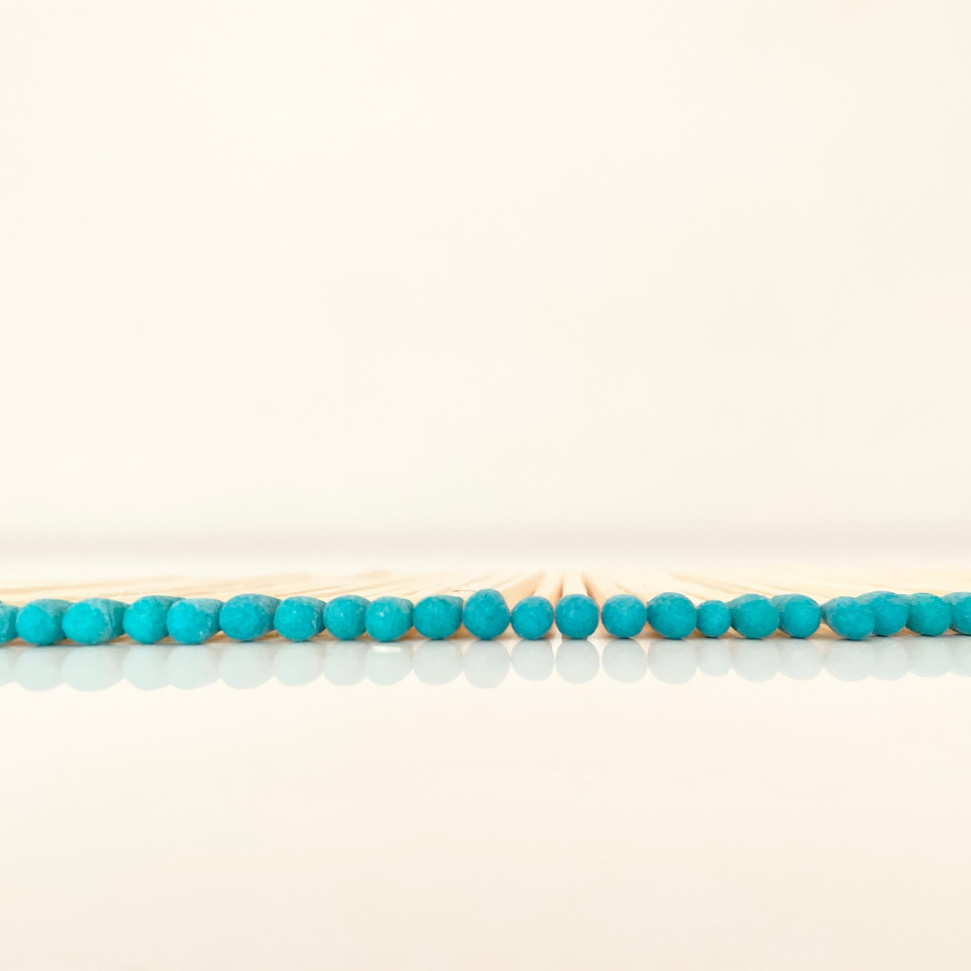 7.5 cm blue matches on a white surface. 