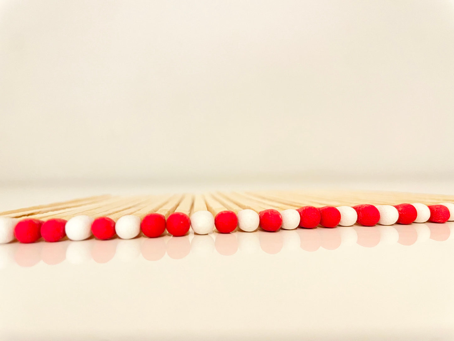 9.8 cm candy cane matches on white surface.