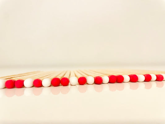 9.8 cm candy cane matches on white surface.