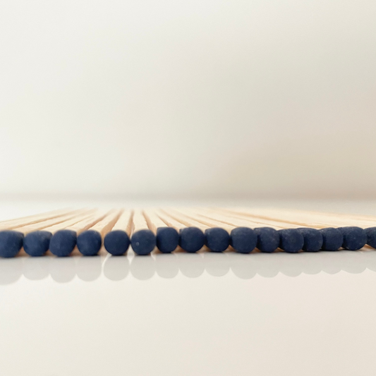 9.8 cm dark blue matches on white surface.