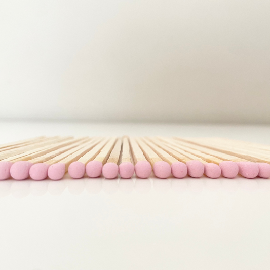 9.8 cm dusky pink matches on white surface.