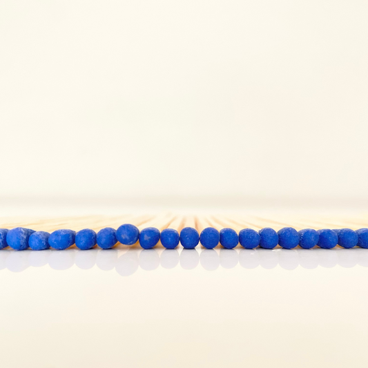 7.5 cm electric blue matches on a white surface. 