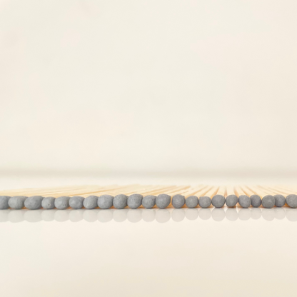 7.5 cm grey matches on a white surface. 