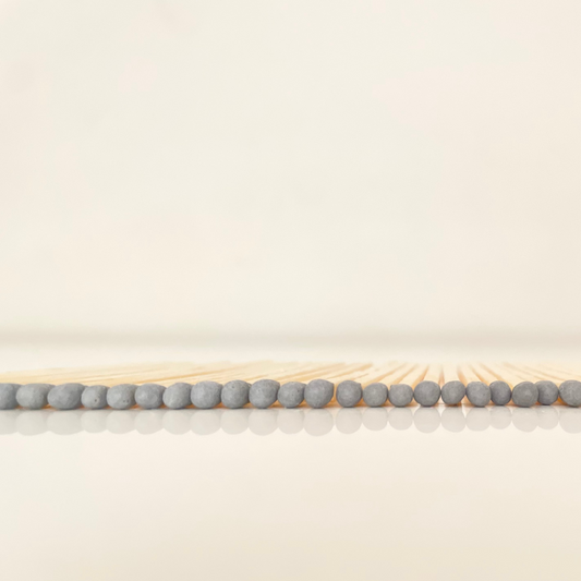 7.5 cm grey matches on a white surface. 