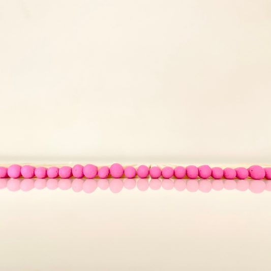 7.5 cm hot pink matches on a white surface. 
