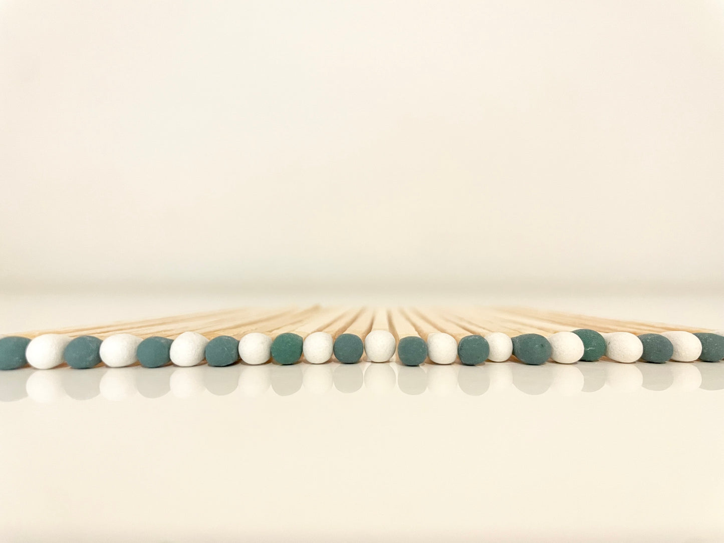 9.8 cm mistletoe matches on white surface.