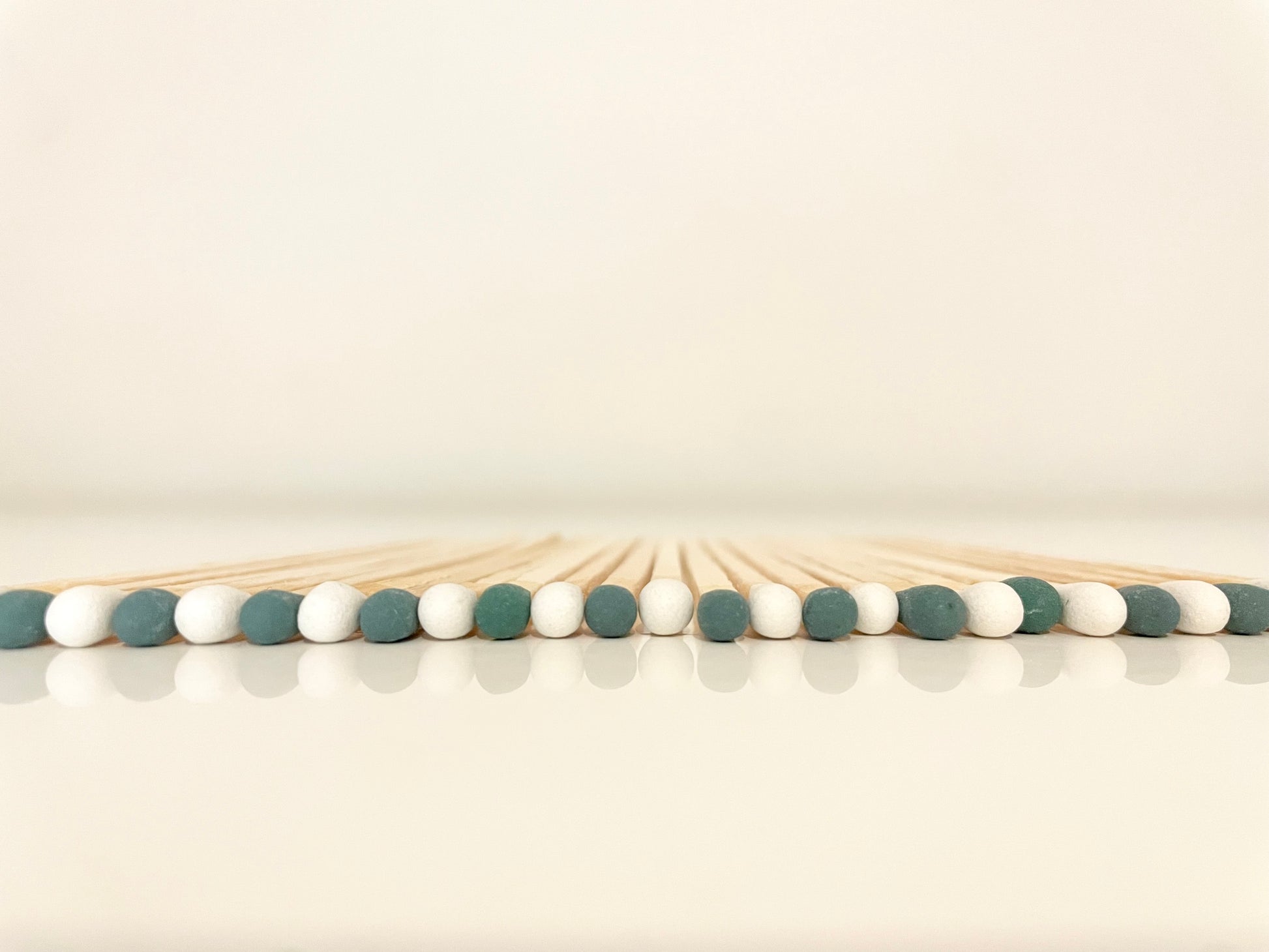 9.8 cm mistletoe matches on white surface.