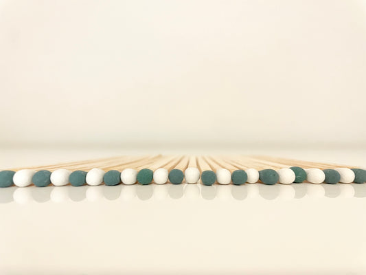 9.8 cm mistletoe matches on white surface.